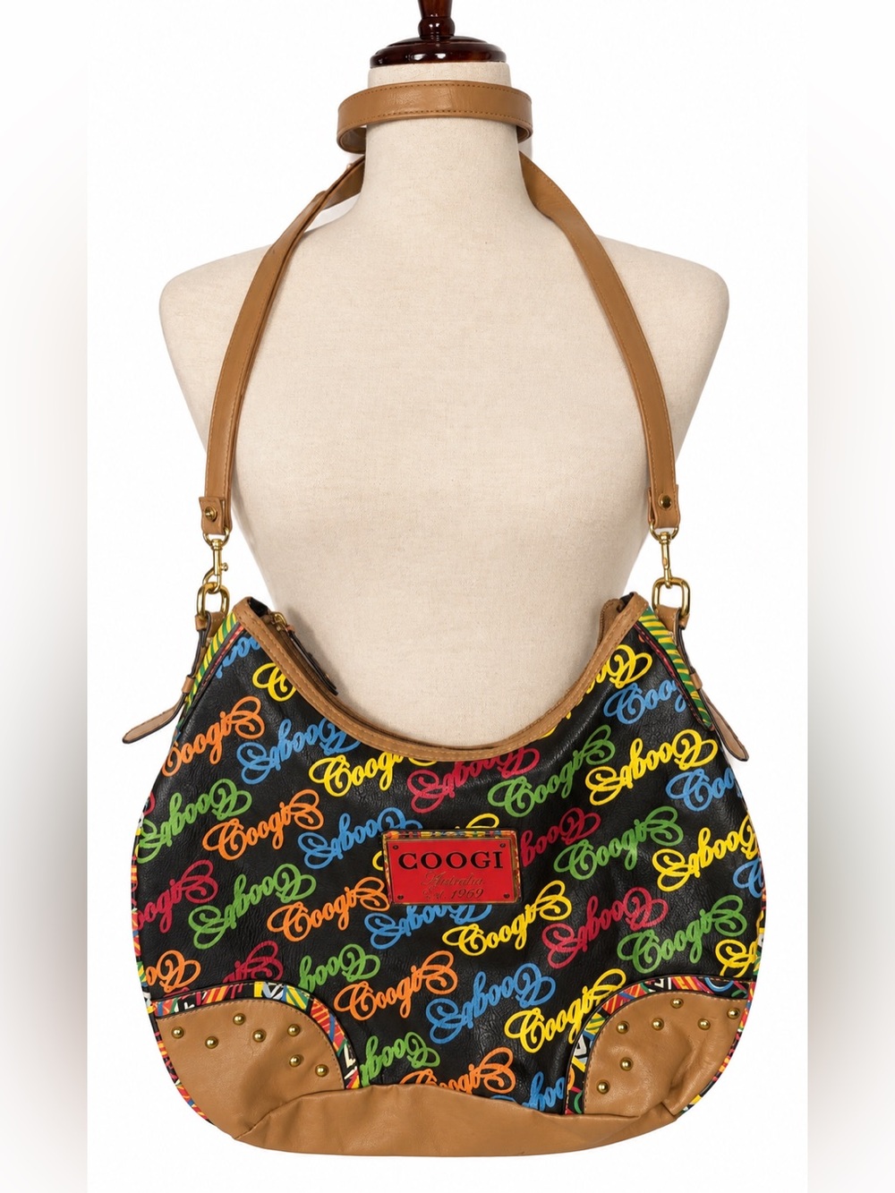 Coogi vintage crossbody bag.  Multicolored w gold & red logo placard, studs, tan